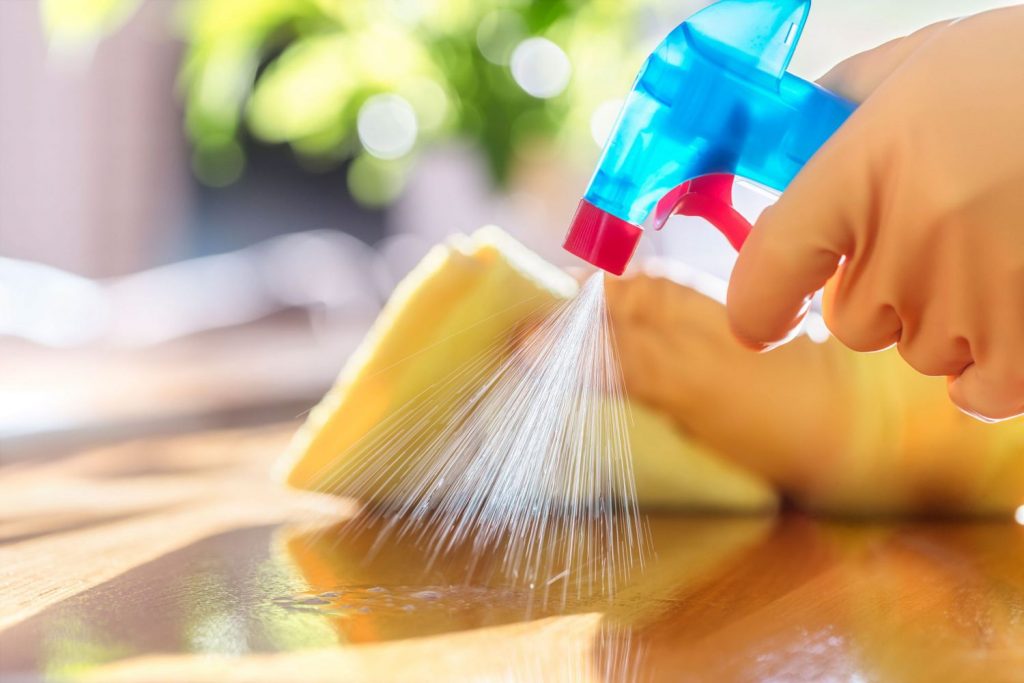 Someone is sanitize and cleaning the table.