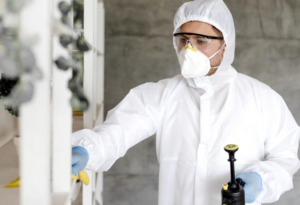 man with suit disinfecting